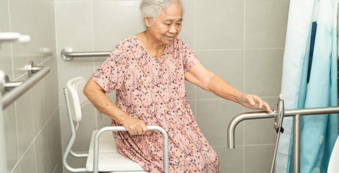 Asian senior or elderly old lady woman patient use toilet bathroom handle security in nursing hospital, healthy strong medical concept.